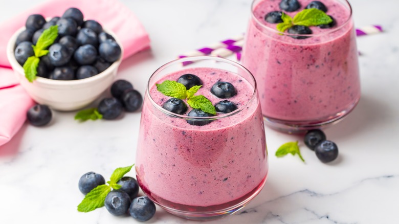 Glasses of blueberry smoothies topped with mint.