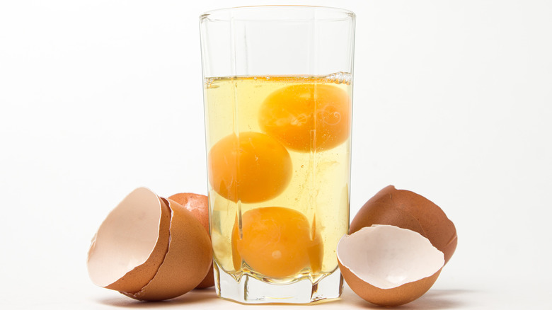 drinking glass with raw eggs