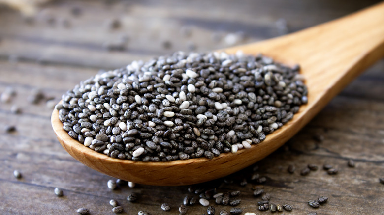 Close up shot of chia seeds in a wooden spoon