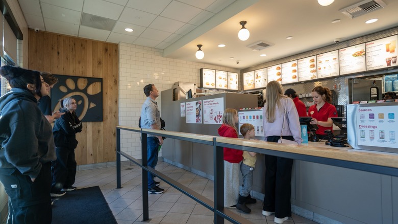 customers queue up in a lobby at a chick-fil-a restaurant