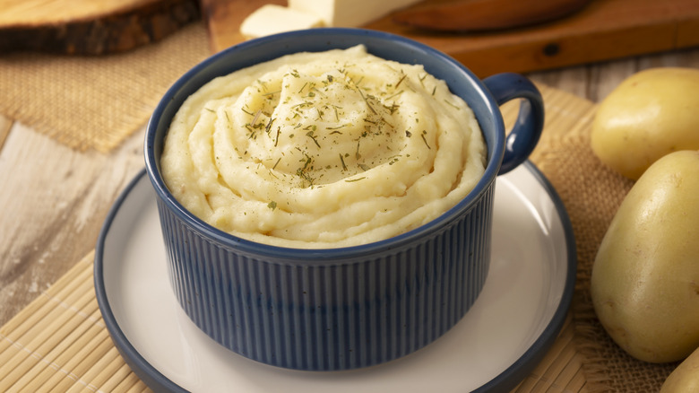 A blue mug of mashed potato