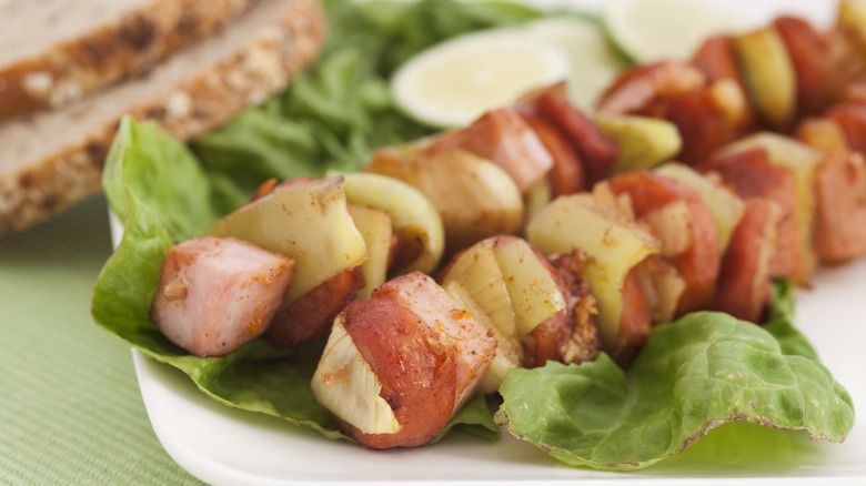 grilled kebabs on a bed of lettuce