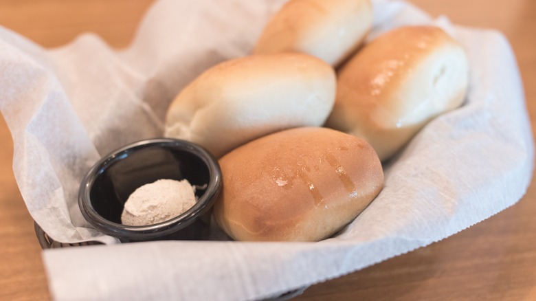 texas roadhouse rolls in basket with honey butter