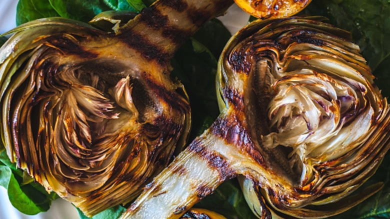 roasted artichokes with grill marks on greens