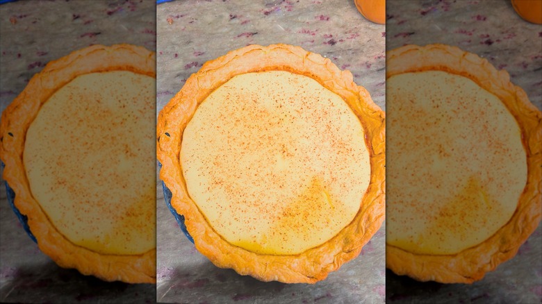 custardy, golden eggnog pie is sprinkled with spices