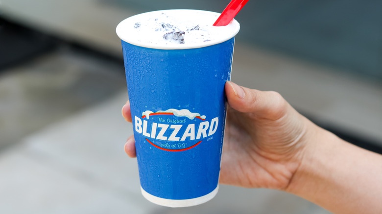 Closeup of hand holding an Oreo Dairy Queen Blizzard.