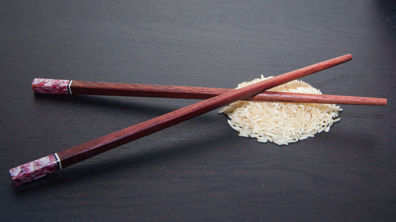 Chopsticks crossed over rice