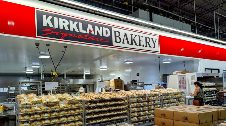 Wide shot of a Kirkland Signature Bakery inside a Costco, with many baked goods stacked high.