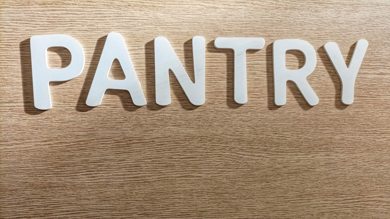 A wooden sign spells the word PANTRY