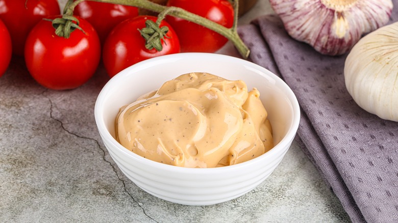 Bowl of yellow cream grill sauce for burgers.