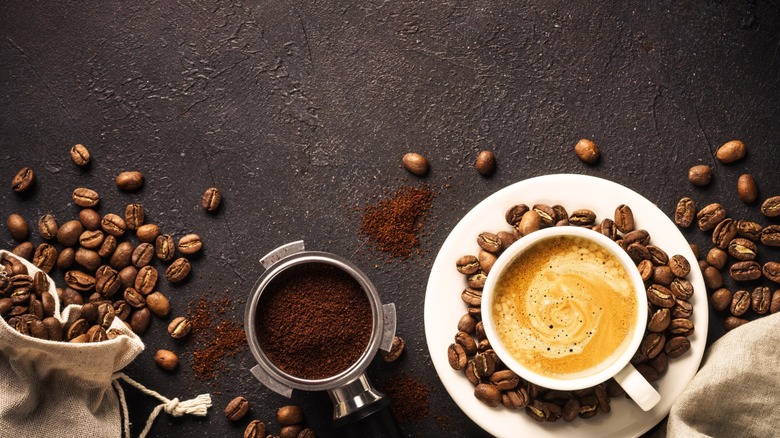 coffee cup, coffee beans, and ground coffee