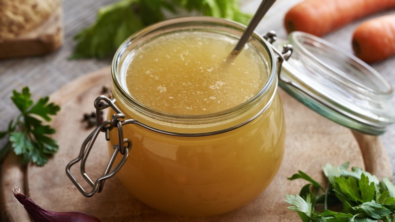 A close-up of a small glass jar filled with soup stock