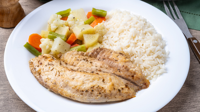 cooked tilapia with white rice and mixed vegetables