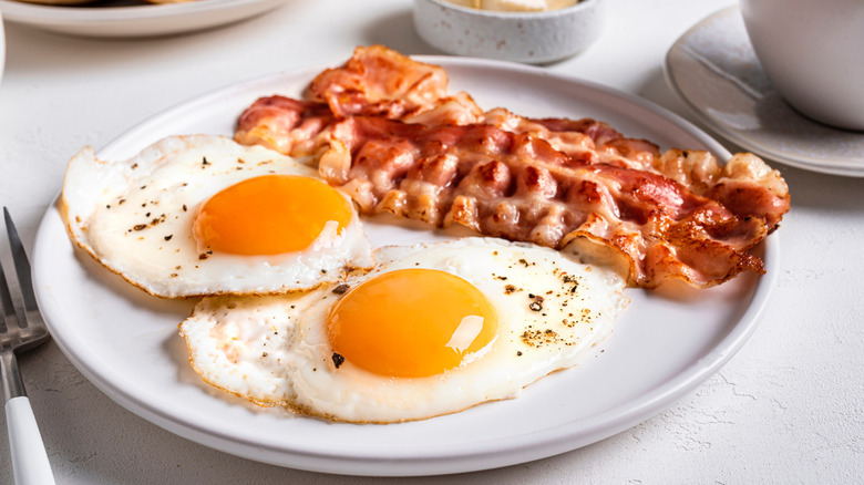 A plate of fried eggs with bacon
