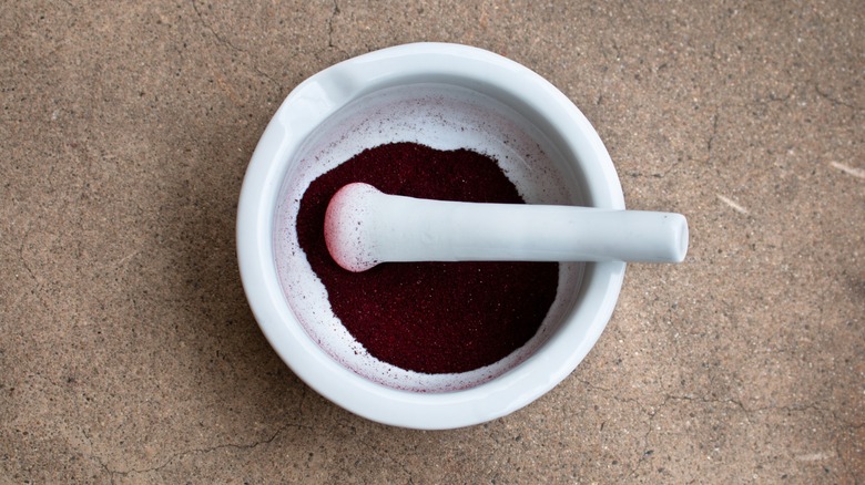 ground cochineal insect shells with mortar and pestle
