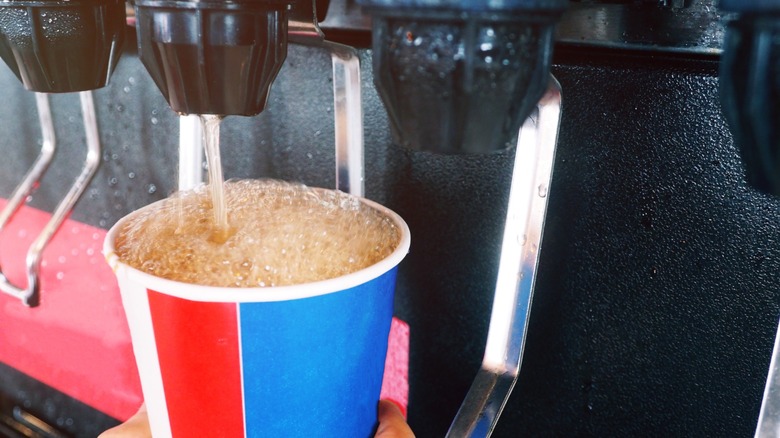 topping off cup at soda fountain