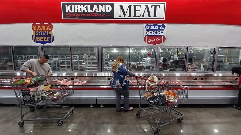 Shoppers peruse the Costco meat department