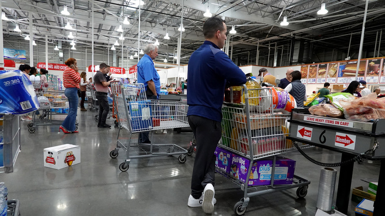 customers wait in line at costco checkout