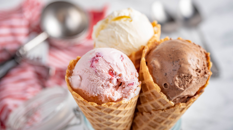 Three small waffle cones with ice cream. 