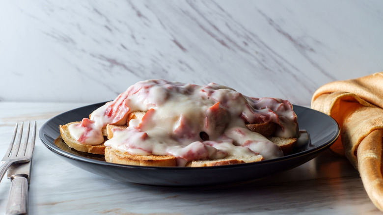 sos or creamed chipped beef on toast with white background