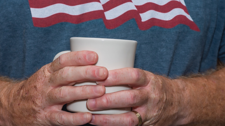 Older man holding a cup of coffee