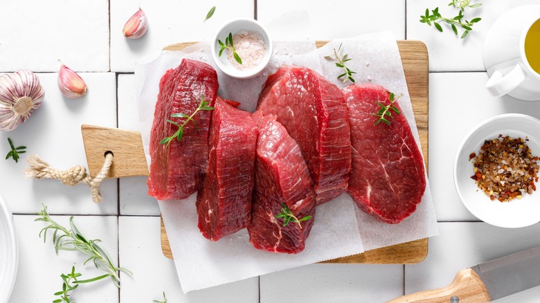 beef tenderloin steaks on white tiles