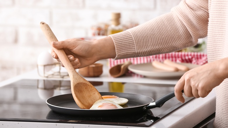 flipping an egg in a pan