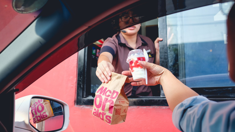 customer goes through mcdonald's drive-thru