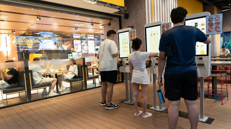 customers at mcdonald's in-store ordering kiosks