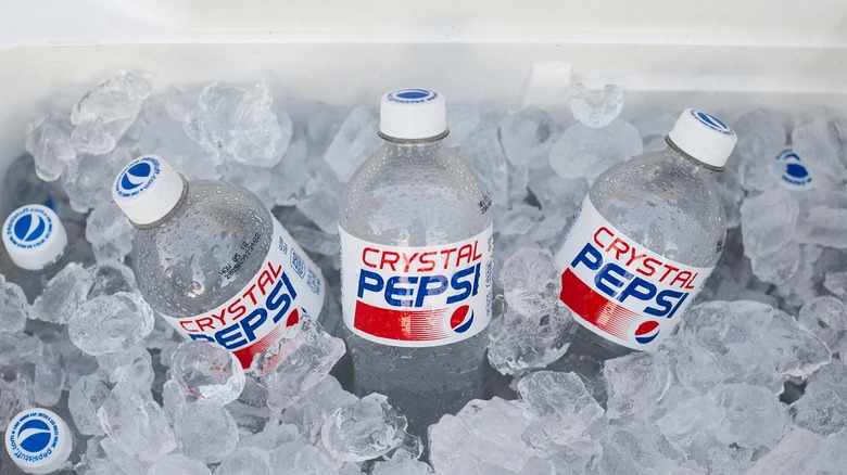 Three bottles of Crystal Pepsi on ice