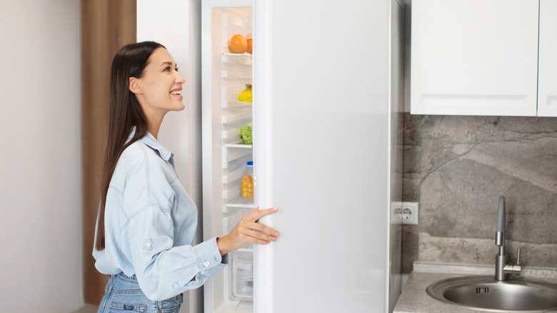 woman looking in fridge