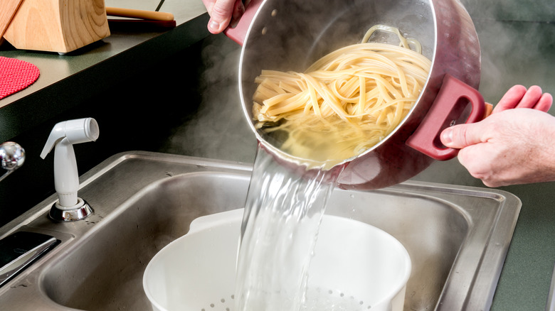 draining pasta water in sink