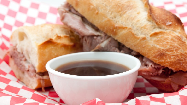 french dip sandwich with cup of au jus