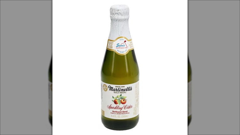 A bottle of Martinelli's apple cider on a white background
