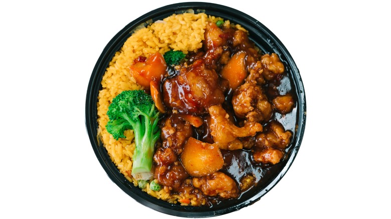 takeout bowl of orange chicken with fried rice