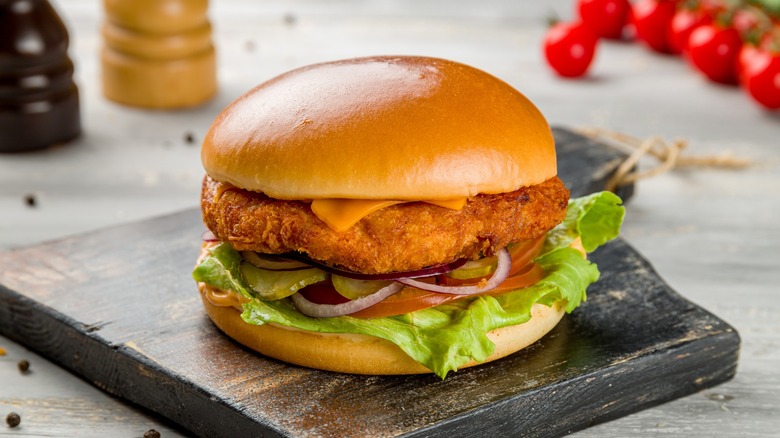 fried chicken sandwich with condiments on bun