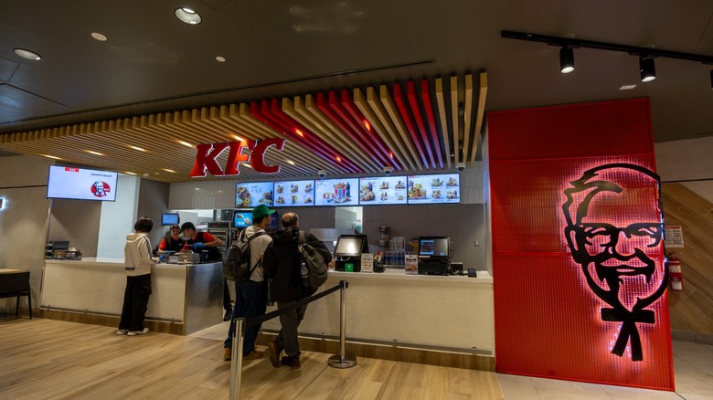kfc outlet at an airport with customers