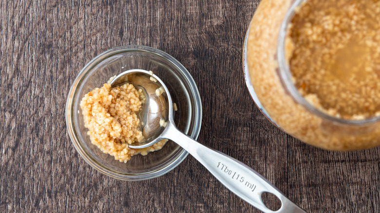 Jar of minced garlic with spoon