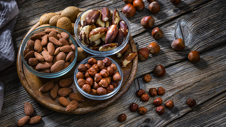 Almonds, hazelnuts, macadamia nuts, and walnuts in bowls