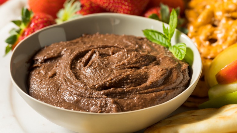 bowl of chocolate hummus surrounded by dippers