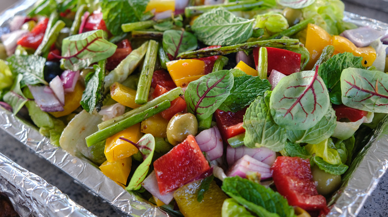 salad in a pair of aluminum trays
