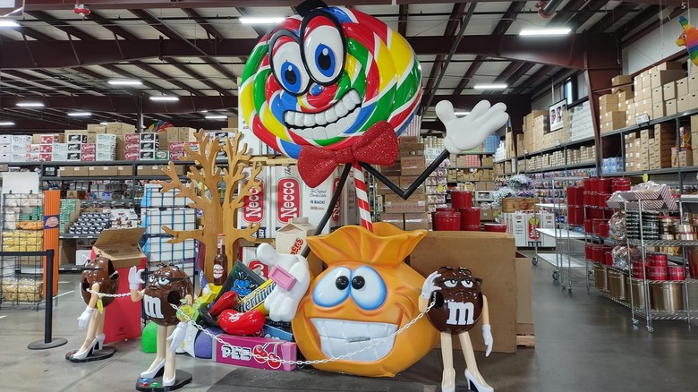 Character display in candy store with M&Ms and a lollipop