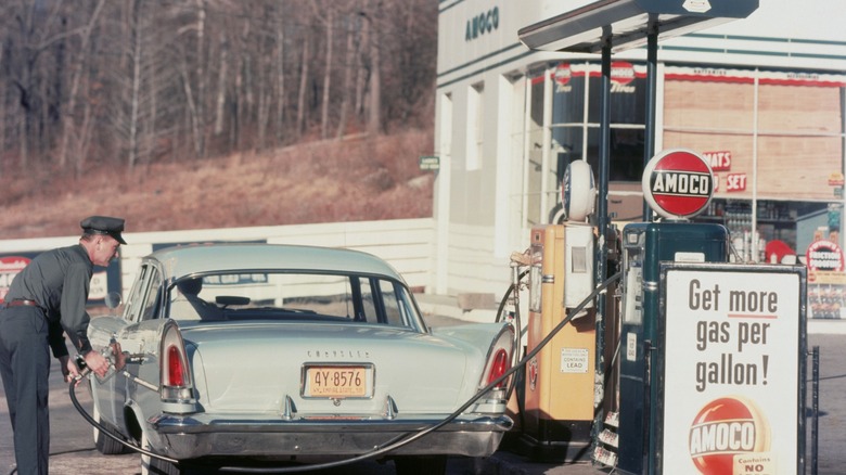 a car gets a fill-up at an old gas station