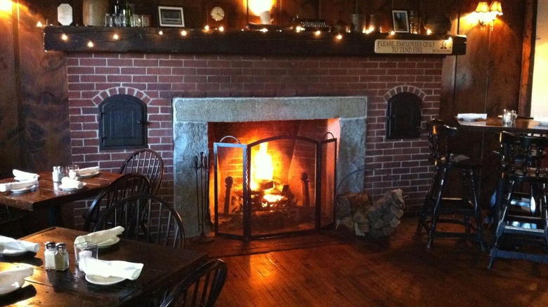 brick fireplace with fire at stone's public house