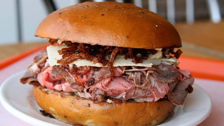 Side view of Roast Beef 1000 sandwich on white plate, closeup.