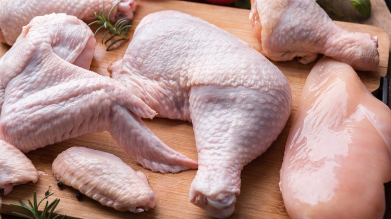 raw chicken pieces on a cutting board