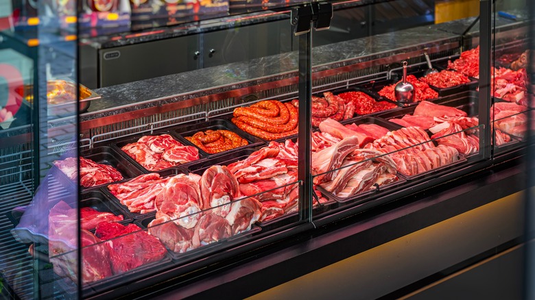 Butcher case with many different cuts and preparations of meat.