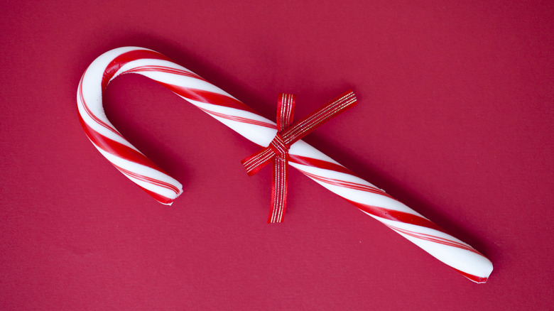 Candy cane on red background