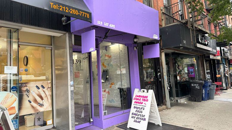 Exterior of Surprise Scoop showing purple facade and signs.