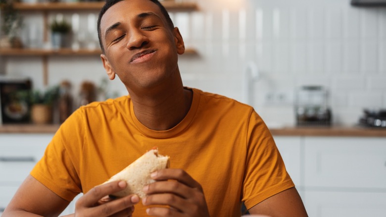 young person eats food